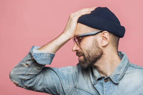 Sideways Shot Displeased Unhappy Man Stubble Keeps Hand Forehead Closes — Stock Photo, Image