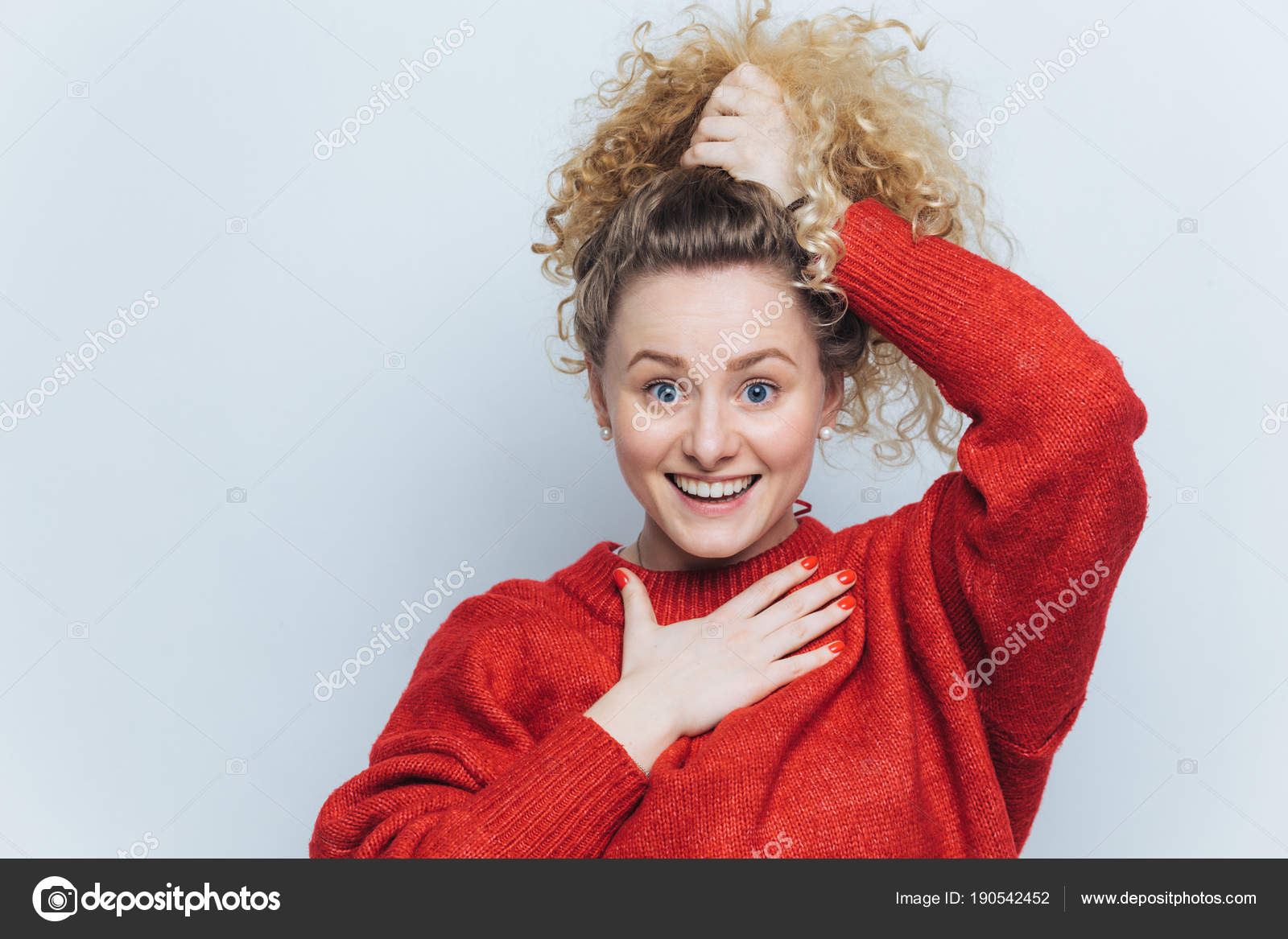 Adorable Excited Young Female With Curly Hair Keeps Hair Tied In Pony Tail Dressed In Casual Adorable Excited Young Female With Curly Hair Keeps Hair Tied In Pony Tail Dressed In Casual