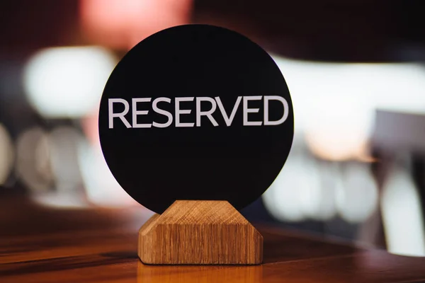 Bokade bord i restaurang med skylt reserverade mot suddiga backgrounnd. Restaurang scen koncept. Reserverade skrivbord för speciella ögonblick. Bord bokat till lunch. — Stockfoto