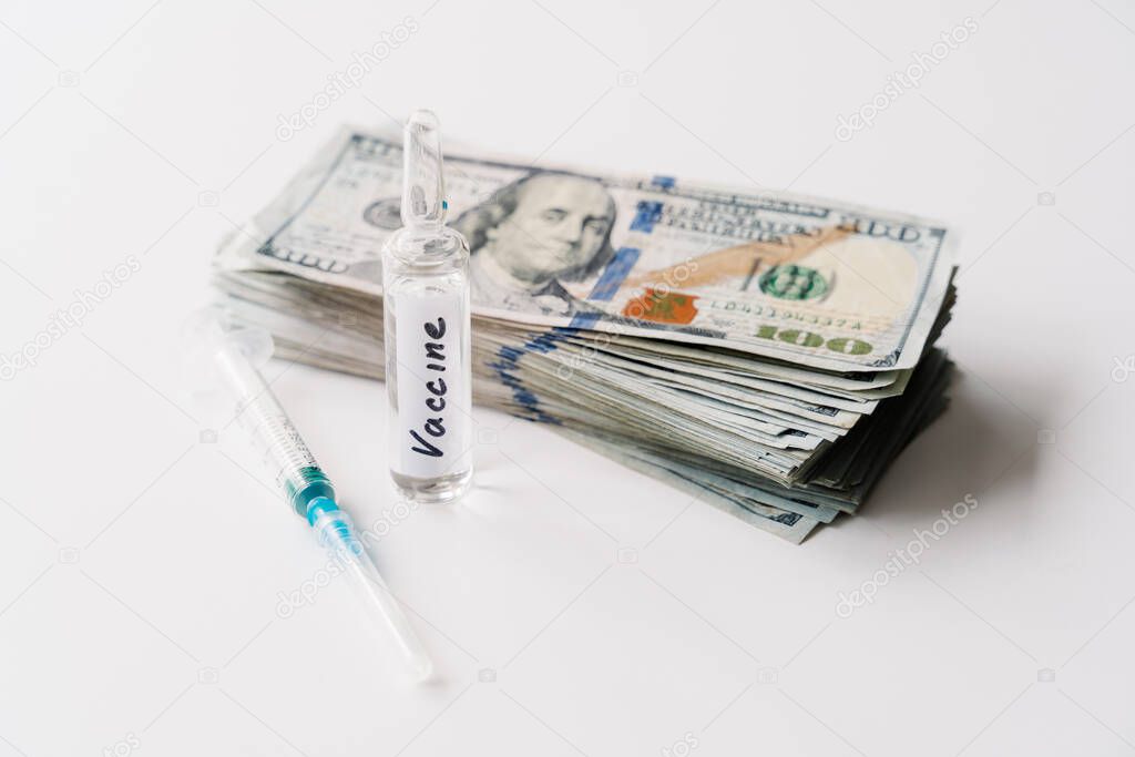 Coronavirus vaccine cost. Injection syringe, vaccine and money on white background. Fight against Covid-19. Pevention, immunization and treatment concept