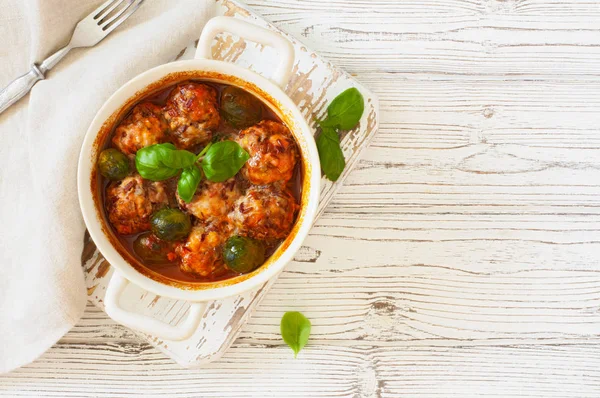 Meatballs and brussel cabbage stewed in tomato sauce — Stock Photo, Image