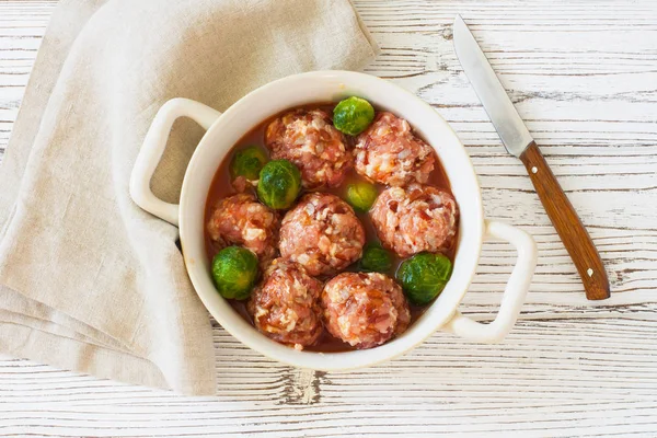 Raw meatballs and brussel sprouts — Stock Photo, Image