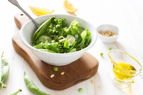 Fresh Vegetable Salad Greens Cucumber Peas Pine Nuts White Wooden — Stock Photo, Image