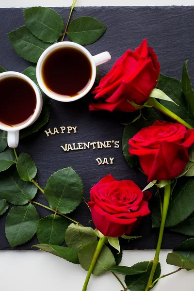 The inscription "Happy Valentine" on a black background with red roses and coffee — Stock Photo, Image