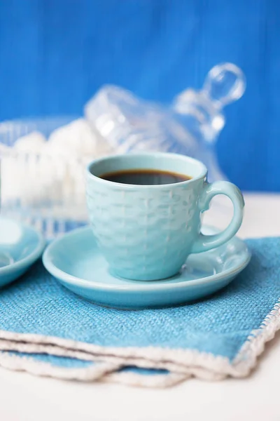 Blue on blue coffee cup and saucer with napkin marshmellou