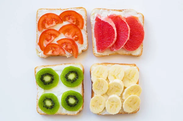 Bright mix of sandwiches for breakfast (fruit, vegetables) — Stock Photo, Image