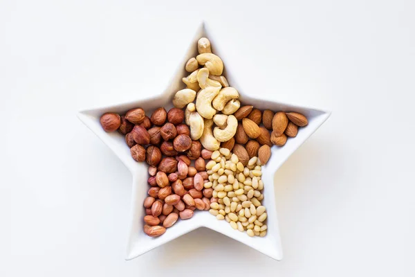 Mixed nuts in a dish in the form of stars — Stock Photo, Image