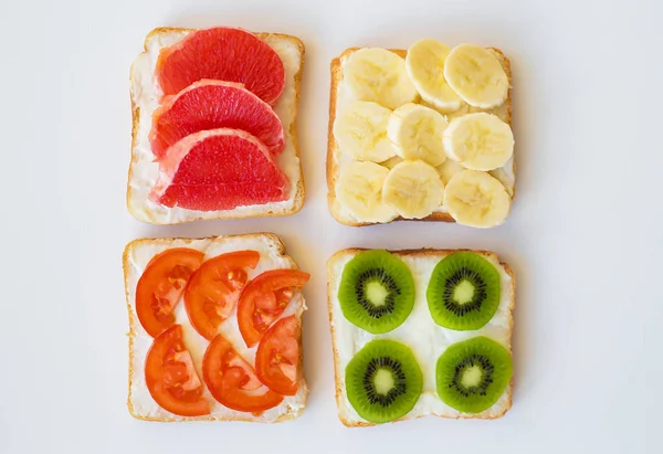 Bright mix of sandwiches for breakfast (fruit, vegetables) — Stock Photo, Image