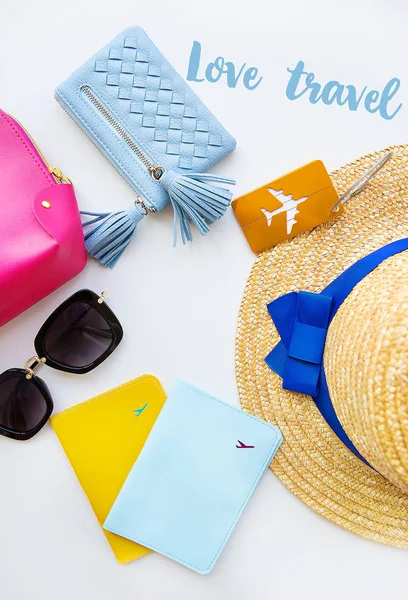 Preparation for vacation - hat, glasses, passport, cosmetic bag, purse. Inscription - love travel