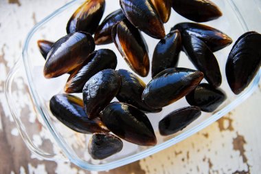 Eski ahşap beyaz masa taze midye.