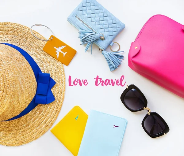Preparation for vacation - hat, glasses, passport, cosmetic bag, purse. Inscription - love travel