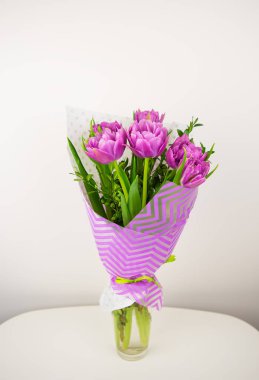 bouquet of beautiful violet lush tulips in a vase