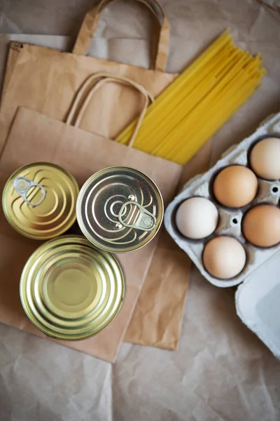 Eggs, canned food, pasta, products in environmentally friendly craft packages. Vegetarian healthy organic foods from the market. Donation, help for those in need.