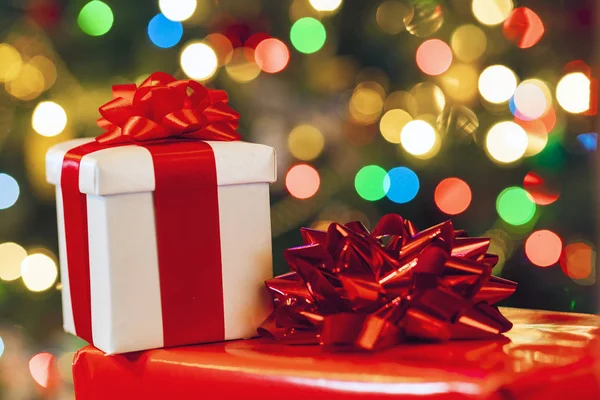 Gift Boxes Ribbon Bow Holiday Lights Background — Stock Photo, Image