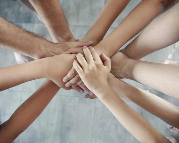 group of people joining hands, success in teamwork