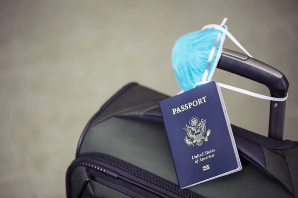 パスポートとインフルエンザウイルスマスク付きの個人的な荷物は コロナウイルス 世界的な流行の概念に対して保護します — ストック写真
