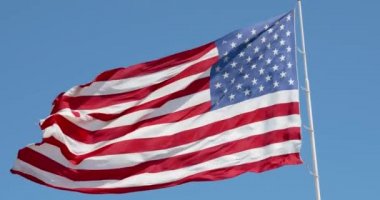 Mavi gökyüzünde rüzgarda dalgalanan Amerikan bayrağı, yakın planda Amerikan bayrağı, açık havada kırmızı mavi bayrak. Amerika Birleşik Devletleri ulusal bayrağı. ABD 'li yıldızlar ve çizgiler, 4k DCI