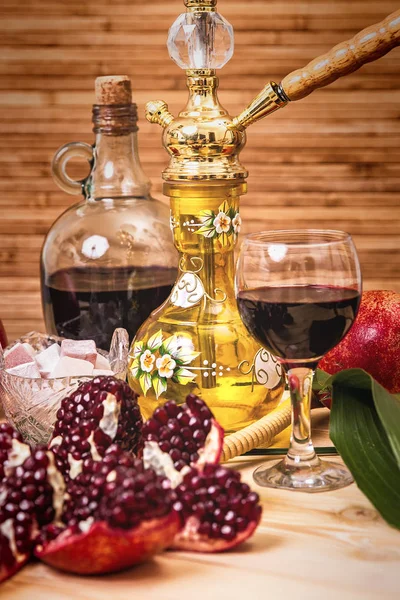 Still-life with Hookah, wine, garnet and sweets — Stock Photo, Image