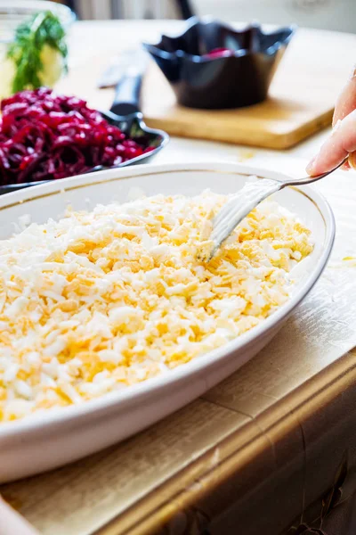 Preparing russian traditional salad herring under fur coat — Stock Photo, Image