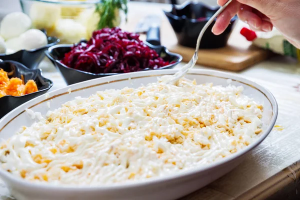 Preparing russian traditional salad herring under fur coat — Stock Photo, Image