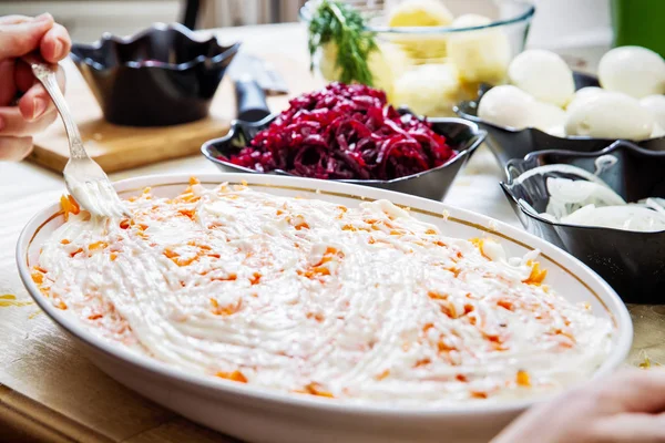 Preparing russian traditional salad herring under fur coat — Stock Photo, Image