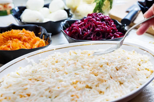 Preparing russian traditional salad herring under fur coat — Stock Photo, Image