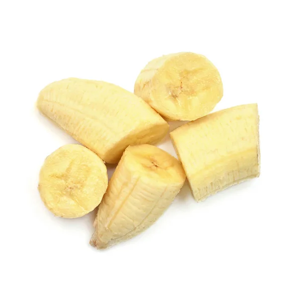 Окремі шматки бананів на білому тлі. Вигляд зверху. — стокове фото