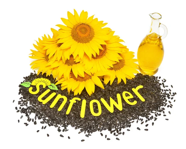 Creative idea flower of a sunflower, seeds and oil glass bottle 스톡 사진