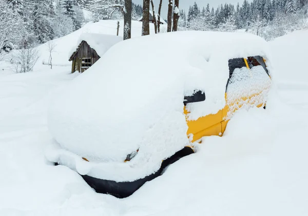 Yellow car under snowdrift. — Stock Photo, Image