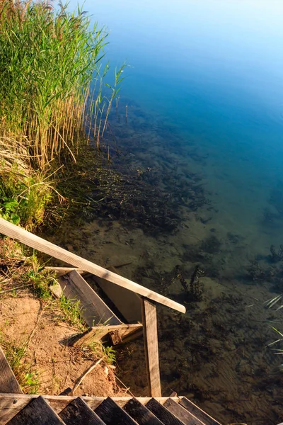 Wooden stairs to summer lake — Stock Photo, Image