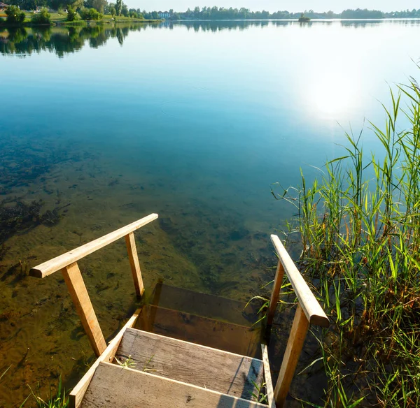 Wooden stairs to summer lake — Stock Photo, Image