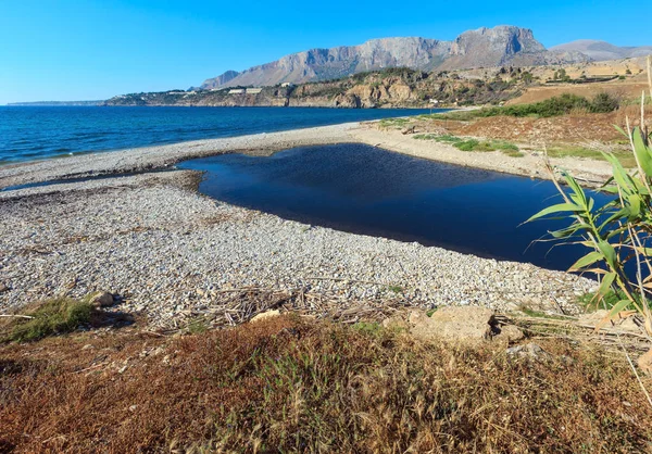 Pequeño río desemboca en el mar en la playa de guijarros —  Fotos de Stock