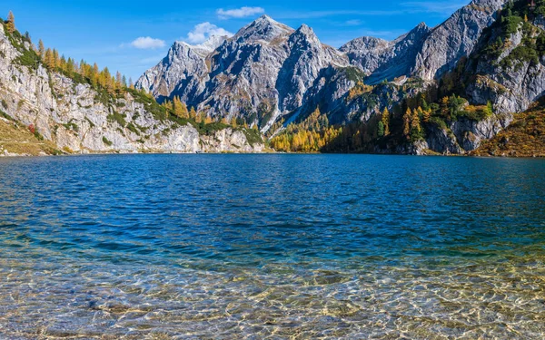 Zonnige herfst alpine Tappenkarsee meer en rotsachtige bergen boven, — Stockfoto