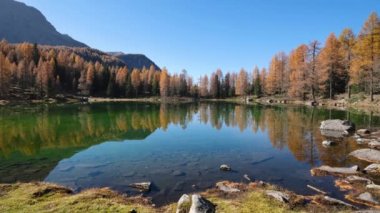 Autumn alpine mountain lake near San Pellegrino Pass, Trentino, Dolomites Alps, Italy. Picturesque traveling, seasonal and nature beauty concept scene.