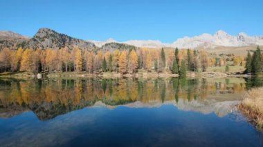 Autumn alpine mountain lake near San Pellegrino Pass, Trentino, Dolomites Alps, Italy. Picturesque traveling, seasonal and nature beauty concept scene.