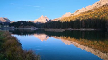 Beautiful autumn evening Lake Misurina and Three Peaks of Lavaredo (Tre Cime di Lavaredo), Dolomites, Italy. Picturesque traveling, seasonal and nature beauty concept scene.