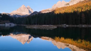 Beautiful autumn evening Lake Misurina and Three Peaks of Lavaredo (Tre Cime di Lavaredo), Dolomites, Italy. Picturesque traveling, seasonal and nature beauty concept scene.
