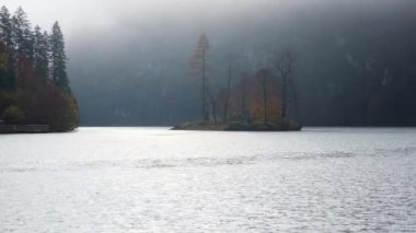 Mountain alpine autumn misty morning lake Konigssee, Schonau am Konigssee, Berchtesgaden national park, Bavaria, Germany. Picturesque traveling, seasonal and nature beauty concept scene.