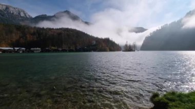 Mountain alpine autumn misty morning lake Konigssee, Schonau am Konigssee, Berchtesgaden national park, Bavaria, Germany. Picturesque traveling, seasonal and nature beauty concept scene.