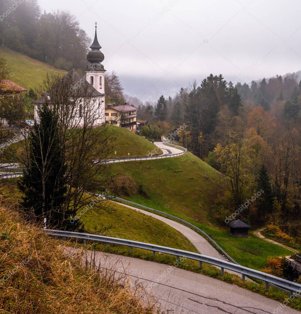 Overcast foggy autumn morning and the small famous Maria Gern pilgrimage church (built in the current form 1708 - 1710), Berchtesgaden, Bavaria, Germany