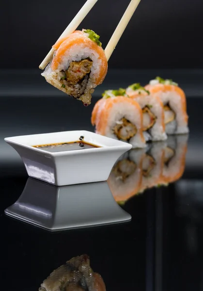 Sushi rolls over black — Stock Photo, Image