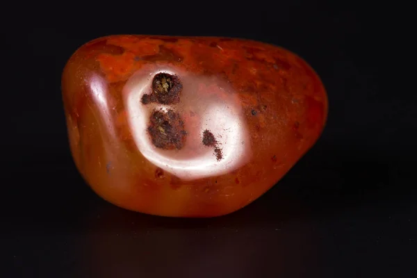 Polished carnelian on black — Stock Photo, Image