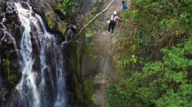 Adventure tourism in tropical Costa Rica while rappelling down a beautiful waterfall  deep in the southern mountains of the country