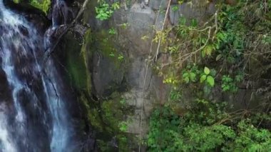 Adventure tourism in tropical Costa Rica while rappelling down a beautiful waterfall  deep in the southern mountains of the country