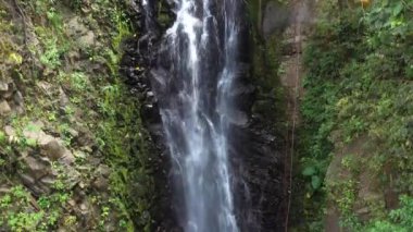 Adventure tourism in tropical Costa Rica while rappelling down a beautiful waterfall  deep in the southern mountains of the country
