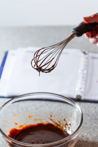 Melted Chocolate Glass Bowl Whisk Open Recipe Book Out Focus — Stock Photo, Image