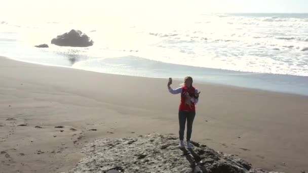 Mujer Pie Debajo Besando Roca Tomando Una Selfie Con Océano — Vídeo de stock