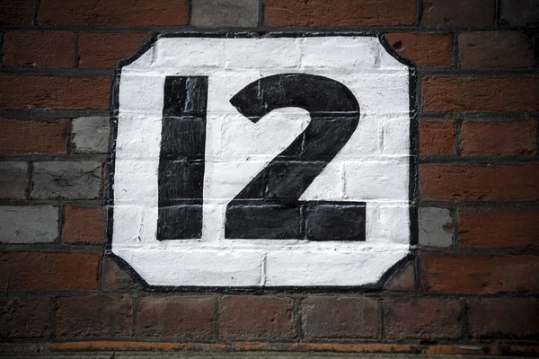 Number twelve hand painted on plaster background — Stock Photo, Image