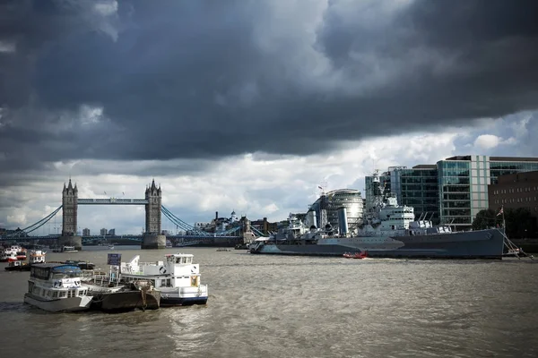 Hms ベルファストと不機嫌そうな空の下でタワー ブリッジ — ストック写真