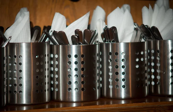 Metal glasses with cutlery and napkins , — Stock Photo, Image